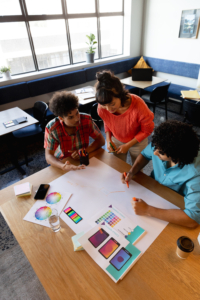 Creative multiracial male and female colleagues discussing business plan in office. Unaltered, teamwork, creative business, workplace, diversity, design occupation.
